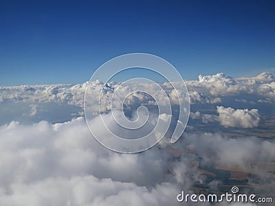 Tranquil Beautiful View From Plane Window at Blue Sky over White Clouds Stock Photo