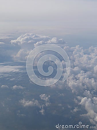 Tranquil Beautiful View From Plane Window at Blue Sky over White Clouds Stock Photo