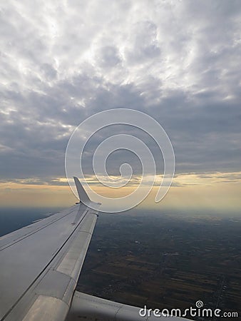 Tranquil Beautiful View From Plane Window at Blue Sky over White Clouds with a Wing Stock Photo