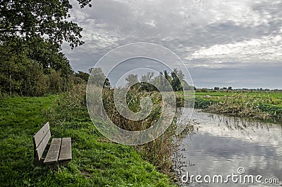 Tranquil bench along a creek Stock Photo