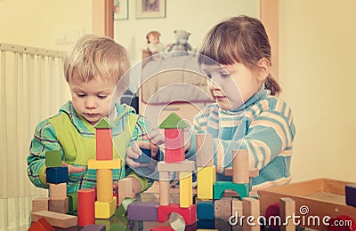Tranquil children playing with wooden toys Stock Photo