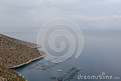 A tranquil coastal landscape with a seafood farm in a calm sea bay Stock Photo
