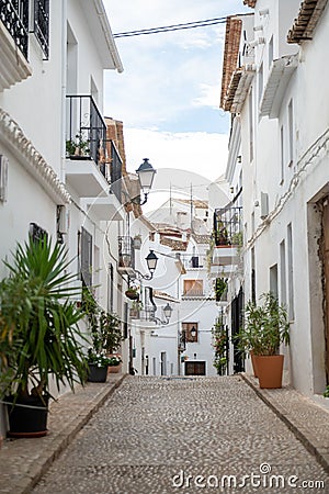 Tranquil cobblestone street with white buildings in Altea, Spain. Editorial Stock Photo