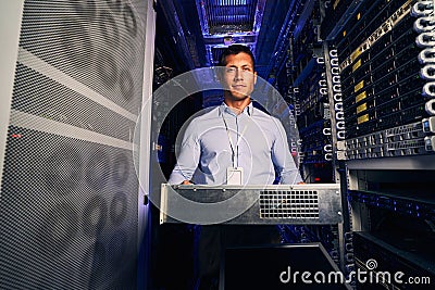 Tranquil data center engineer installing new hardware component Stock Photo