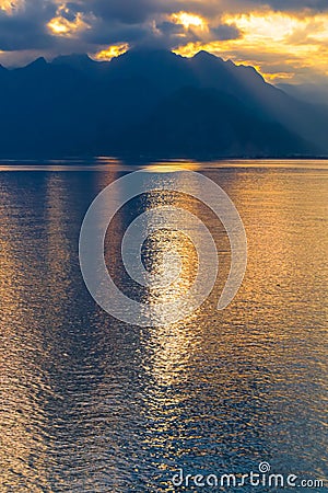 Tranquil lake illuminated by the setting sun, casting a mesmerizing reflection Stock Photo