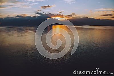 Tranquil lake illuminated by the setting sun, casting a mesmerizing reflection Stock Photo