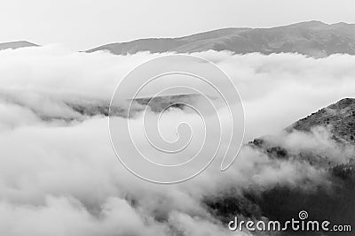 A tranquil mountain scene with clouds cover on a hill. Black and Stock Photo