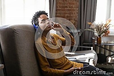 Tranquil peaceful young Black girl enjoying relaxing music for meditation Stock Photo