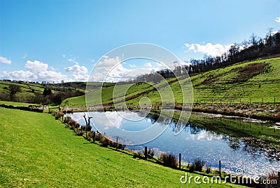 Tranquil pond in rolling English countryside Stock Photo