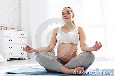 Tranquil pregnant woman looking for balance Stock Photo
