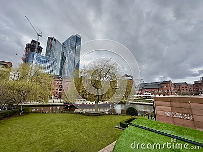 Tranquil scene of a peaceful river in the park Deansgate-Castlefield, Manchester, United Kingdom Editorial Stock Photo