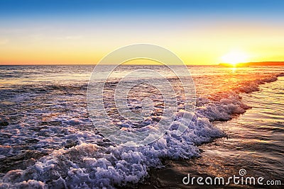 Tranquil sunset on the beach Stock Photo