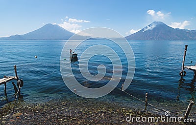 Tranquil view on lake Atitlan with view on volcano peaks in Santa Cruz la Laguna, Guatemala Stock Photo