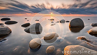 Tranquil view of sunset with stones in the water. On shore the Baltic Sea in Estonia. Stock Photo