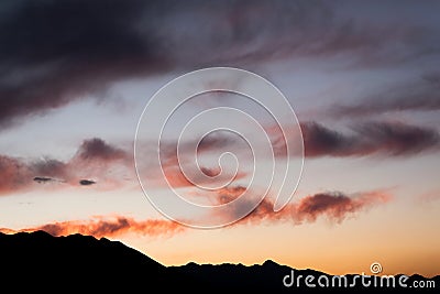 Tranquillity view sunset sky against mountain silhouette Stock Photo