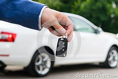 Transfer of a car to a new owner for money, ignition keys in the managers hand Stock Photo