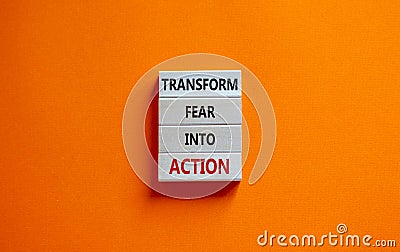 Transform fear into action symbol. Businessman holds wooden blocks with words `Transform fear into action`. Beautiful orange Stock Photo