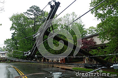 transformer on a pole and a tree laying across power lines over a road after Hurricane moved across Stock Photo