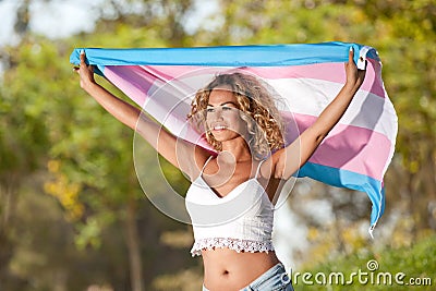 Transgender female with pride flag Stock Photo