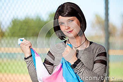 Transgender gripping pride flag in hands Stock Photo