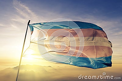 Transgender Pride flag textile cloth fabric waving on the top sunrise mist fog Stock Photo