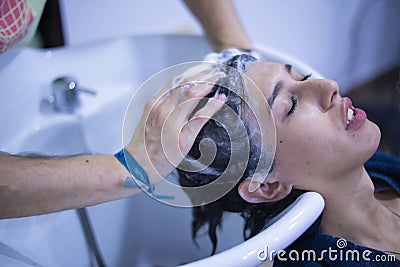 Transgender woman shampooing her hair for a keratin treatment at a hair salon. Transgender concept, hairdresser, beauty Stock Photo