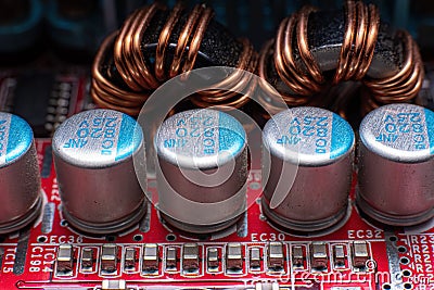 Transistors and coils on a red motherboard Stock Photo