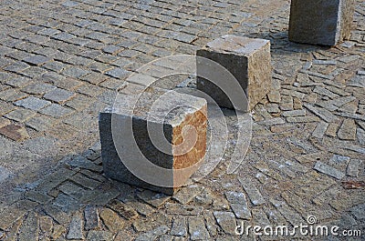 Transition of paved surfaces between paving and lawn. the lawn grows between individual randomly placed stones of granite chipped Stock Photo