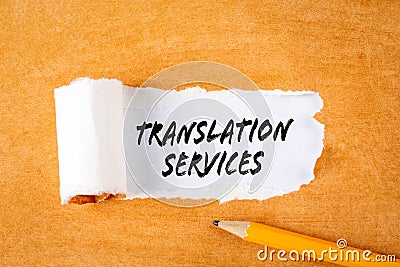 Translation Services. Business concepts. Pencil on an orange cardboard background Stock Photo
