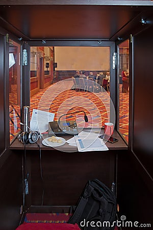 Translator room . translators cubicle . interpreting - Microphone and switchboard in an simultaneous interpreter booth . Soft focu Editorial Stock Photo