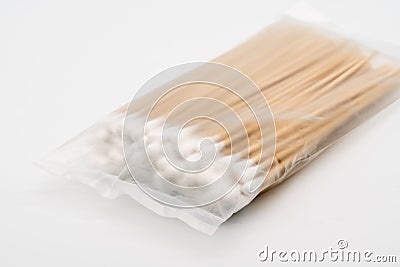 A translucent plastic pack of pasteurized cotton wool on bamboo Stock Photo