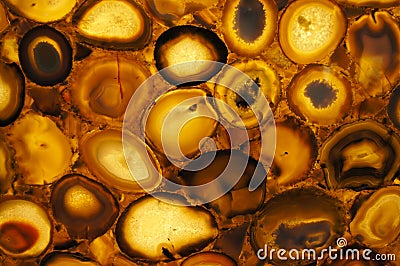 A translucent slice of natural stone agate. Natural patterns and textures of minerals for background. Natural stone agate surfaces Stock Photo