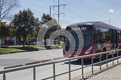 A Transmilenio bus in movement transitin over North highway in sunny day Editorial Stock Photo