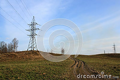 Transmission tower on the hill against blue sky Stock Photo