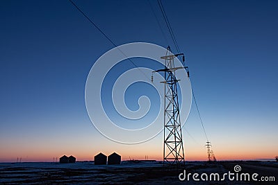 Transmission Tower Silhouetted at Sunset Stock Photo