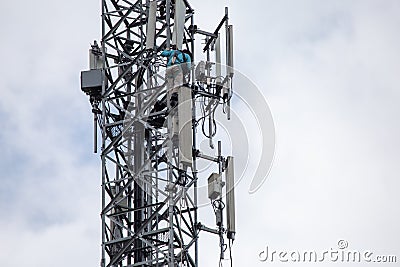 transmitter atop a cell phone pole About to be upgraded from 4g to 5g. High-risk electrical engineer job in Thailand Stock Photo