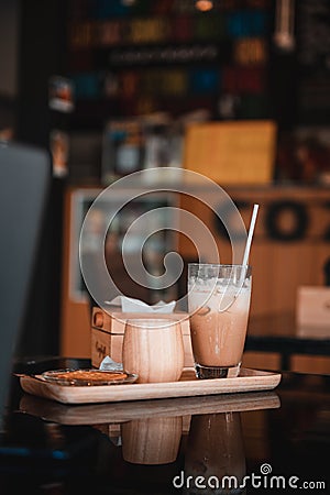 Transparent coffee cup Hot cappuccino on the table in a coffee shop with people Stock Photo