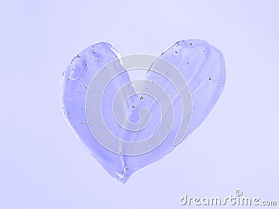 Transparent cosmetic gel heart shape on violet Stock Photo