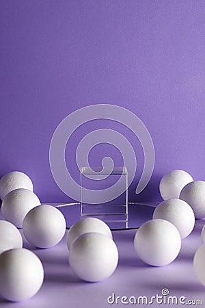 transparent cube and white balls on purple background for product Stock Photo
