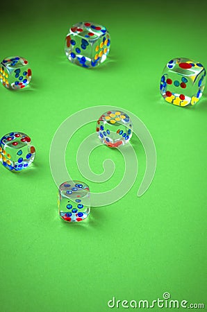 Transparent cubes for casino/transparent cubes for casino are scattered on green cloth. Top view Stock Photo