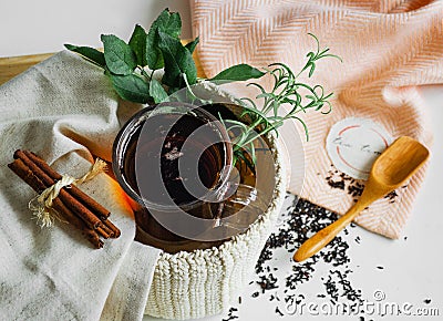 Transparent Cup of tea brewed with adjacent wooden spoons. Cinnamon sticks. Tea time. Tea leafs, Flat Lay Stock Photo