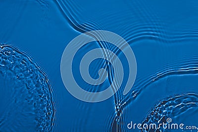 transparent dark blue colored clear calm water surface texture Stock Photo