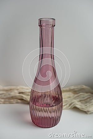 Transparent dark red glass vase filled with water Stock Photo