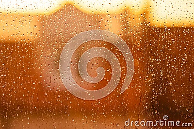 Transparent drops of rain on the window in the rays of the sunset Stock Photo