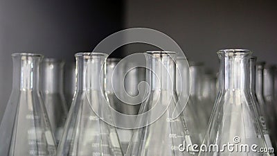 Transparent Erlenmeyer flasks or conical flasks on shelf in science laboratory, use for measuring solvent or solution. Stock Photo