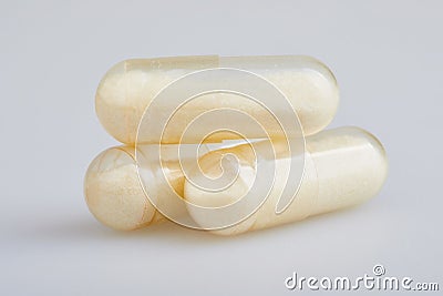 Transparent gelatin capsules with zink powder on white background. Stock Photo