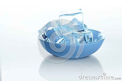 Transparent ice cubes bowl on white background with water drops Stock Photo