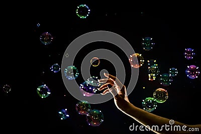 The transparent, iridescent soap bubbles isolated on black. Stock Photo