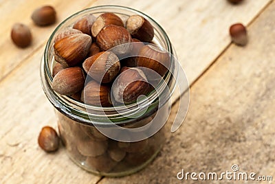 Transparent jar full of hazelnuts Stock Photo