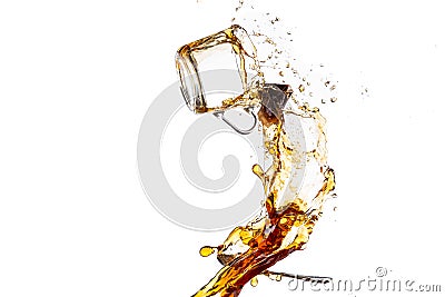 Transparent mug with black tea turned upside down and falls with a splash and spray Stock Photo